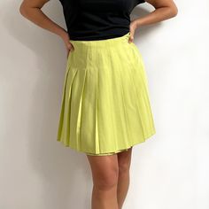 Gorgeous, bright vintage short pleated skirt in juicy lime green. It has wide, sharp pleats all around, stitched down at the waist, and an invisible zip at the back. The skirt is made from a single layer of heavy, yet soft fabric with a nice fall. A smart, youthful skirt for a smart or a casual look. Made by Dorothy Perkins. 50% viscose, 50% polyester. Small size, labelled as 12UK, more of a present day size 8-10UK. Measurements when laid flat are: Waist: 36cm Hips: 54cm Length: 50cm. Excellent, Spring Solid Color Tennis Skirt With Pleated Hem, Casual Summer Skort With Accordion Pleats, Casual Skort With Accordion Pleats For Summer, Summer Accordion Pleated Mini Skirt, Summer Flared Mini Skirt With Accordion Pleats, Spring Pleated Full Tennis Skirt, Solid Color Pleated Waist Tennis Skirt For Summer, Spring Full Pleated Tennis Skirt, Pleated Full Tennis Skirt For Summer