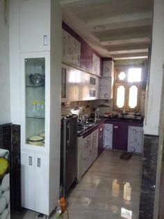 a kitchen with white cabinets and black counter tops in the middle of an unfinished room