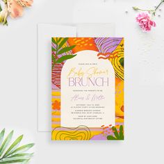 an orange, yellow and pink floral brunch is on the table next to some flowers