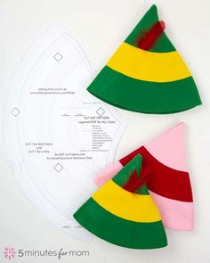 three pieces of paper with different colored hats on top of each other, and one piece is cut out to make a christmas tree ornament