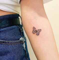 a small butterfly tattoo on the left arm