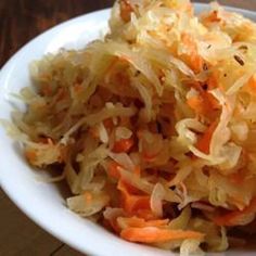 a white plate topped with cabbage and carrots