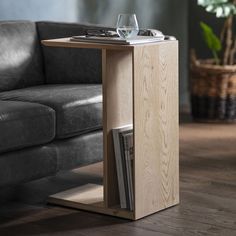 a table that has some wine glasses on it and a magazine rack underneath the table