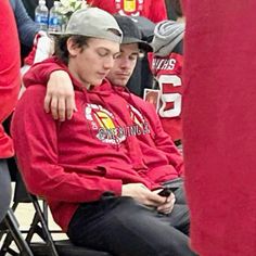 two young men sitting next to each other