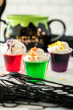 three different colored desserts sitting on top of a table