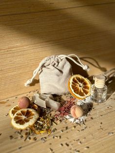 an assortment of dried fruits and spices on a wooden table next to a drawsack bag