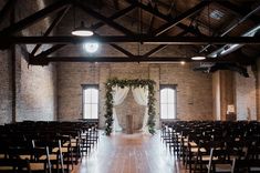 an indoor wedding venue with rows of chairs