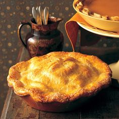 a pie sitting on top of a wooden cutting board