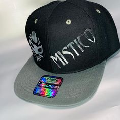 Mistico Snapback Custom Cap Hat Add a touch of style to your outfit with this Mistico Snapback Fit Adjustable Cap Hat. The black color and foil silver detailing give it a unique look that is perfect for any occasion, whether it's a casual day out or a party. The hat is made of acrylic and has a canvas fabric type, making it lightweight and breathable. It is also adjustable, making it a perfect fit for anyone. The cap hat features the popular art theme and is Custom Iron Pressed. This hat is a must-have for anyone who loves travel, lucha libre, or wrestling. Get your hands on this stylish cap hat today! RETURNS I Offer A 30 Day Free Return Policy Once The Item Has Been Delivered To You, In Case You Need to Return The Item (Unused) The Buyer Must Open A Case With eBay and Give a Reason For T Stylish Caps, Custom Caps, Free Labels, Art Theme, Popular Art, Hands On, Canvas Fabric, Caps Hats, Black Color