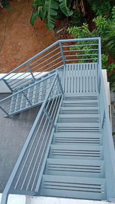 an overhead view of a set of stairs in front of some trees and bushes on the ground