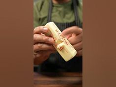 a man holding a piece of cheese in his hands