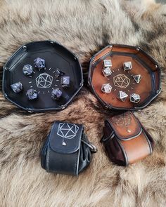 four leather dice trays sitting on top of a fur covered floor