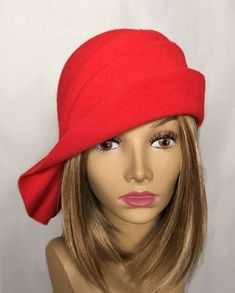 This beautiful ladies cloche is made from velour fur felt, and hand draped over an antique hat block. Hand finished with authentic millinery techniques. Please indicate your head size measurement when ordering (measure your head horizontally just above your eyebrows). When you receive your hat, there will be a small ribbon inside to fine-tune the fit, and a hat box for safe storage. Note: Colors will vary depending on your monitor and there will also be some variations due to dye lots. I persona Elegant Red Felt Hat For Formal Occasions, Elegant Red Cloche Hat For Winter, Red Fitted Felt Hat For Formal Occasions, Elegant Fitted Red Felt Hat, Formal Red Fitted Felt Hat, Elegant Red Cloche Hat With Curved Brim, Red Fitted Cloche Hat With Curved Brim, Red Fitted Cloche Hat With Short Brim, Fitted Red Cloche Hat With Short Brim