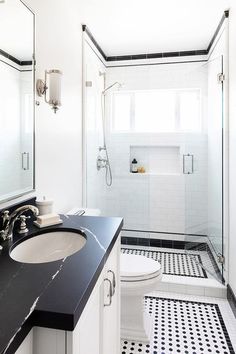 a bathroom with black and white tile flooring