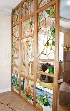 a large stained glass window sitting inside of a living room next to a wall mounted tv