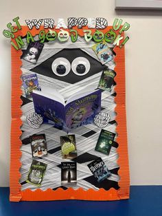 an orange and white book display with books in the shape of a penguin reading a book