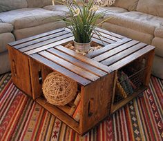 a coffee table made out of pallet wood with a potted plant on top