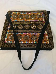 Handmade handbag... A colourful and unusual bag, handmade in the heart of pakistan sindh using original materials and traditional methods of patchworking and embroidery.. Rectangular Shoulder Bag With Multicolor Embroidery, Rectangular Multicolor Embroidery Bag For Festivals, Traditional Rectangular Shoulder Bag With Motifs, Multicolor Embroidered Rectangular Shoulder Bag, Black Rectangular Shoulder Bag For Festivals, Rectangular Shoulder Bag With Motifs, Embroidered Rectangular Shoulder Bag For Festivals, Rectangular Embroidered Shoulder Bag For Festivals, Festive Rectangular Shoulder Bag With Mirror Work