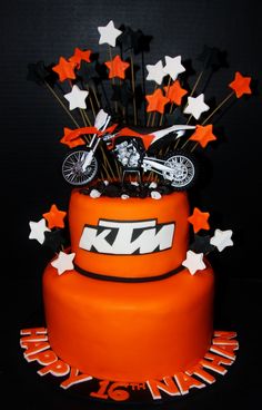 a motorcycle themed birthday cake with stars on the top and an orange frosting layer