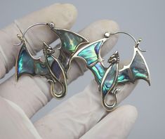 Dragon earrings, hand made brass ,abalone inlay and  sterling silver post, price per pair. THESE ARE HAND MADE JEWELRY, hand carve with love and passion individually , there is typically a slight difference between the two earrings. Please have a look at Photos, colors may a little bit vary from the actual look, and due to Monitor Displayed settings and lighting when shoot with camera. SIZE please have a look at images for detail dimensions, size and weights. MAKE SURE YOU WANT THE WEIGHTS AND D Adjustable Unique Jewelry With Dragon Design, Unique Silver Jewelry With Dragon Design, Gold Dragon Earrings, Silver Dragon Design Collectible Jewelry, Earrings Dragon, Dragon Earrings, Jewelry Hand, Hand Made Jewelry, Jewelry Earrings Dangle