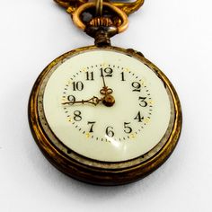 "Antique small open face Swiss pocket watch, having round form 800 silver case, decorated with light blue guilloche enamel. On the back, there are gold floral patterns with a bird in the middle. Watch has white color face with black Arabic numerals, gold dot hour marks and two hands. It comes with a gold-filled figural scroll form watch pin. This glorious watch is 1 1/16\" in diameter, pin is 7/8\" tall and 13/16\" wide. Watch needs cleaning. Eb9327" Yellow Gold Self-winding Round Pocket Watch, Timeless Self-winding Pocket Watch For Collectors, Elegant Self-winding Collectible Pocket Watch, Antique Self-winding Medallion Pocket Watch, Art Nouveau Antiques, Collectible Self-winding Yellow Gold Pocket Watch, Business Checks, Gold Dots, Swiss Watches