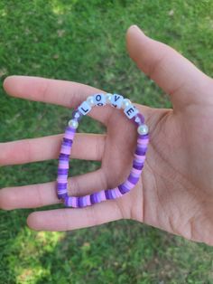 "This is the Lavender Love bracelet! This bracelet has gorgeous shades of purple with the word \"Love\" right in the middle! This bracelet is super stunning. I can imagine paring it with a simple white & purple aesthetic outfit! If you love the thought of love, and love the color purple, this bracelet is made just for you! <3" Personalized Purple Bracelets For Everyday, Everyday Personalized Purple Bracelets, Personalized Purple Bracelet For Everyday, Trendy Personalized Purple Stretch Bracelet, Personalized Purple Beaded Bracelet, Trendy Purple Stretch Bracelet With Letter Beads, Purple Stretch Bracelet With Letter Beads As Gift, Purple Stretch Bracelet With Letter Beads For Gift, Trendy Personalized Purple Friendship Bracelets