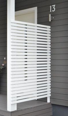 a white door on the side of a gray house