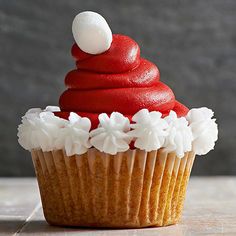 a cupcake with red icing and white frosting