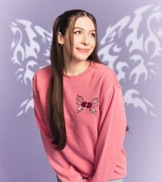 a girl with long hair wearing a pink sweatshirt