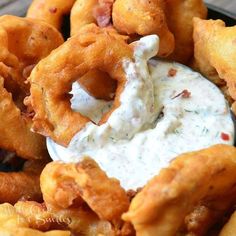 fried onion rings with ranch dip on top