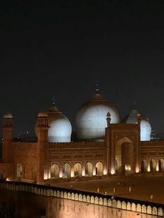 an image of a building that is lit up at night time with lights on it