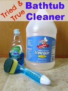 a bottle of vinegar and a toothbrush sitting on a counter with the words tried & bathtub cleaner next to it