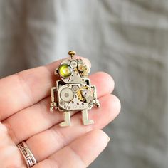 "Green eye Robot Brooch. Steampunk Brooch. Robot Brooch. Android Brooch. Android. Robot lovers gift. Robot steampunk. Steampunk gift. Gift for him. Gift for her. Funny Brooch. Handmade steampunk. ROBOT BOY is unique, never the same and never meet ! Size Robot - 1\" x 1,4\" It is great idea for steampunk or robot-android stylization. This parts of clockwork is authentic and old. Unique, luxury gift for an unconventional person. You will get the Brooch from photos. Packed into a gift organza bag. Novelty Brooch Jewelry Gift, Handmade Metal Brooches For Gifts, Handmade Metal Brooches As Gifts, Unique Metal Brooch Gift, Metal Lapel Pin Brooch As Gift, Silver Novelty Pins For Gifts, Handmade Retro Brooches For Gifts, Silver Novelty Brooches For Gifts, Steampunk Brooch