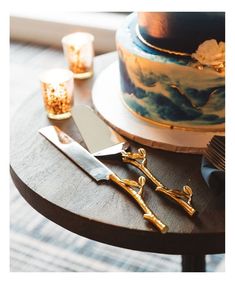 there is a cake on the table with two knives next to it and some candles