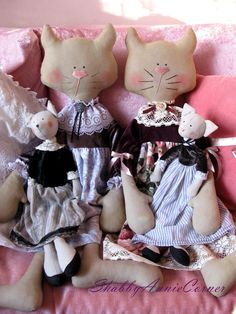 three stuffed animals sitting on top of a pink couch next to two other stuffed animals