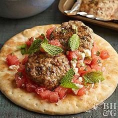 a meatball and tomato pizza on a pita with a serving dish in the background