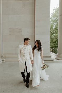 a bride and groom holding hands in front of the lincoln memorial