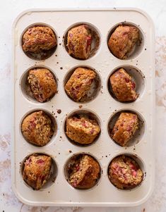 twelve muffins in a white tray on a marble countertop, ready to be eaten