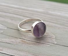 This solid sterling silver ring makes a great gift!  It has a cabochon of purple and green fluorite.  The stone is 12mm. Ring Size: 10 Band Width: 2.5mm Bezel (circle) Size: 12mm *SEE my store for cufflinks, tie clips, tie tacks, bracelets, & earrings. This would be a great gift for any time of the year! Perfect for a wedding, for a Christmas gift, anniversary gift, or a birthday. Please let me know if you have any questions. #H25 Classic Cabochon Amethyst Ring As Gift, Classic Amethyst Cabochon Ring As Gift, Gift Amethyst Ring With Bezel Setting In Sterling Silver, Cabochon Amethyst Ring In Sterling Silver For Anniversary, Amethyst Cabochon Ring In Sterling Silver For Anniversary, Anniversary Cabochon Amethyst Ring In Sterling Silver, Sterling Silver Amethyst Ring For Healing, Silver Amethyst Ring With Bezel Setting As Gift, Sterling Silver Cabochon Amethyst Ring