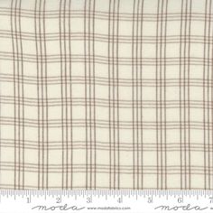 a white and brown plaid fabric on a ruler