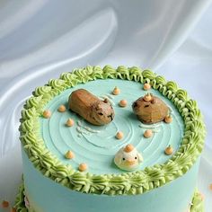 there is a cake decorated with two dogs and mice on it's top layer