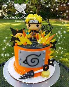 a birthday cake with an image of naruto on it and some decorations around it