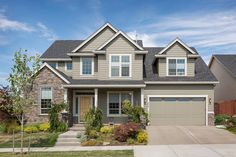 a large house with two garages in the front and one on the back side