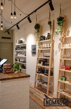 the inside of a store with shelves and plants