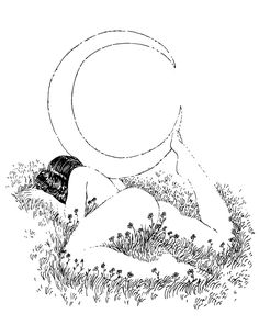 a woman laying in the grass with her back to the camera while holding a crescent