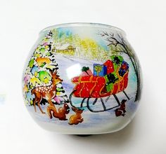 a glass vase with a painting of santa's sleigh on it