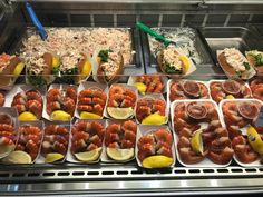 lobsters and other seafood are on display in trays