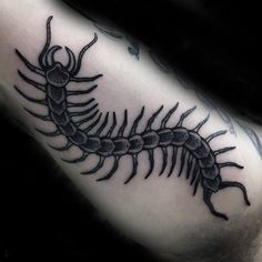 a black and white image of a scorpion tattoo on the arm, done by an artist