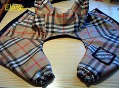 a pair of plaid pants sitting on top of a wooden table