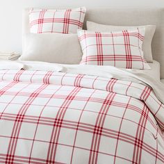 a red and white plaid comforter set on a bed